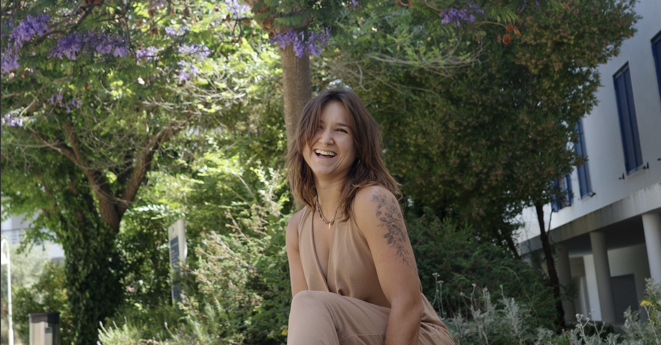 Zuza laughing outdoors in the Algarve, warm daylight